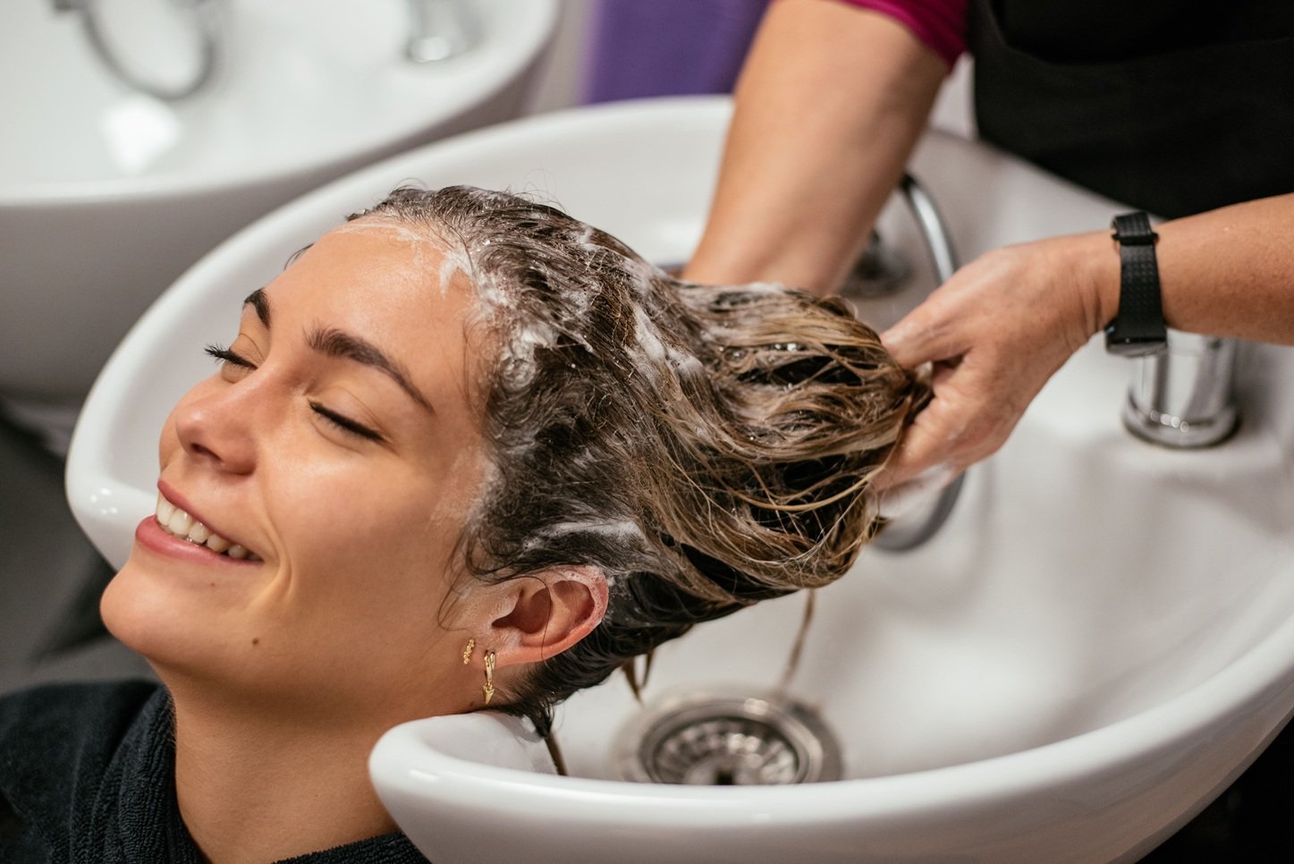 a woman applying apple cider vinegar for balanced scalp